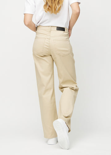 Beige loose jeans set bagfra, så man kan se hele produktet.
