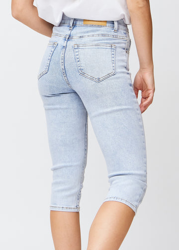 Tæt billede af de lyseblå denim slim capris bagfra, så man tydeligt kan se detaljer og lommer.