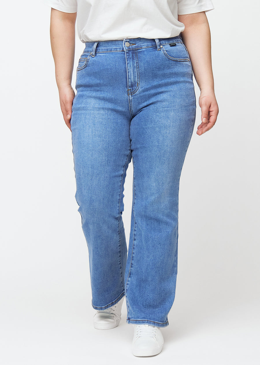 Blå mid-rise bootcut jeans i denimfarven Rivers, som sidder tæt fra hofte til lår og har et let svaj forneden, på en plus-size model, set forfra.