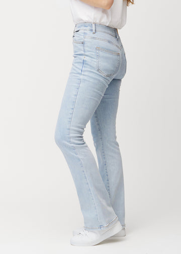 Lyseblå mid-rise bootcut jeans i denimfarven Waves set fra siden på model.