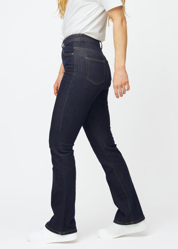 Dyb mørkeblå denim jeans til kvinder i farven Midnights med bootcut pasform set fra siden på model.