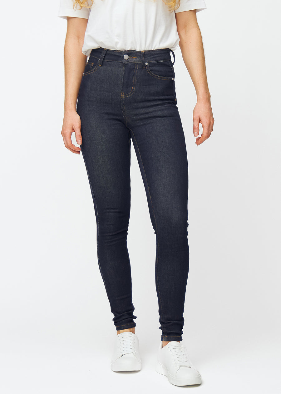 Dyb mørkeblå denim jeans til kvinder i farven Midnights med skinny pasform, der sidder tæt fra talje til ankel, set forfra.