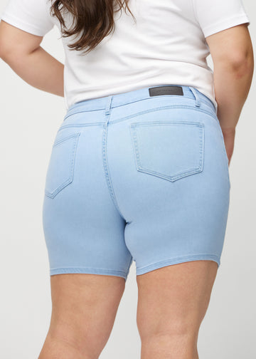 Lyseblå skinny short shorts set bagfra tæt på en plus-size model for at vise detaljer.