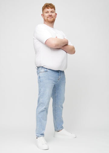 Fuldt billede af en plus-size model i lys denim regular jeans.
