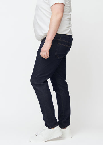 Dyb mørkeblå denim jeans til mænd i farven Midnights med slim pasform set fra siden på plus-size model.