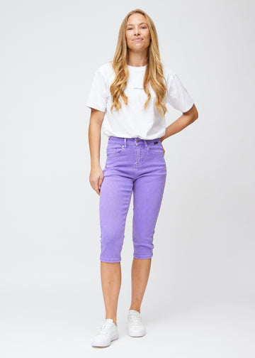 Fuldt billede af model iført lilla slim capris.